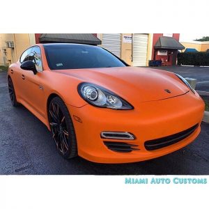 Porsche Panamera wrapped in Matte Orange vinyl