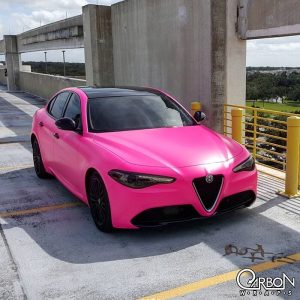 Alfaromeo Giulia wrapped in Neon Fluorescent Pink vinyl