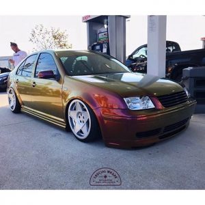 Volkswagen Jetta wrapped in Avery ColorFlow Gloss Rising Sun Red/Gold shade shifting vinyl