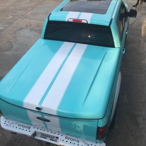 Ford F150 wrapped in Gloss Mint Blue vinyl