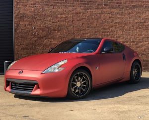 Nissan 370z wrapped in Satin Red Aluminum vinyl